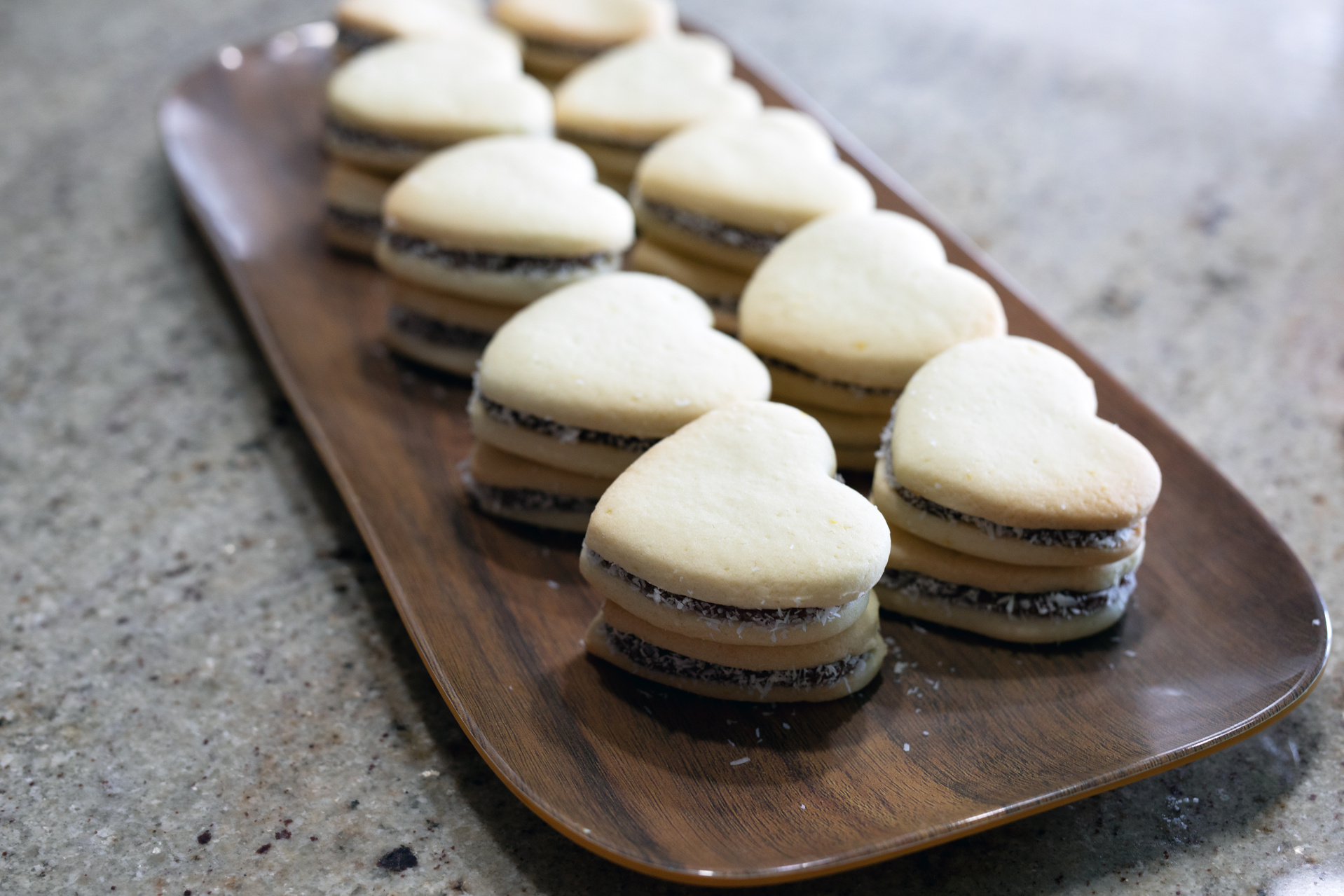 Alfahores cookies on a wooden tray