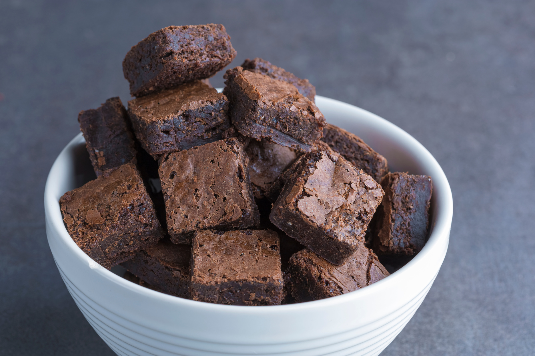 brownie cubes in a white bowl,