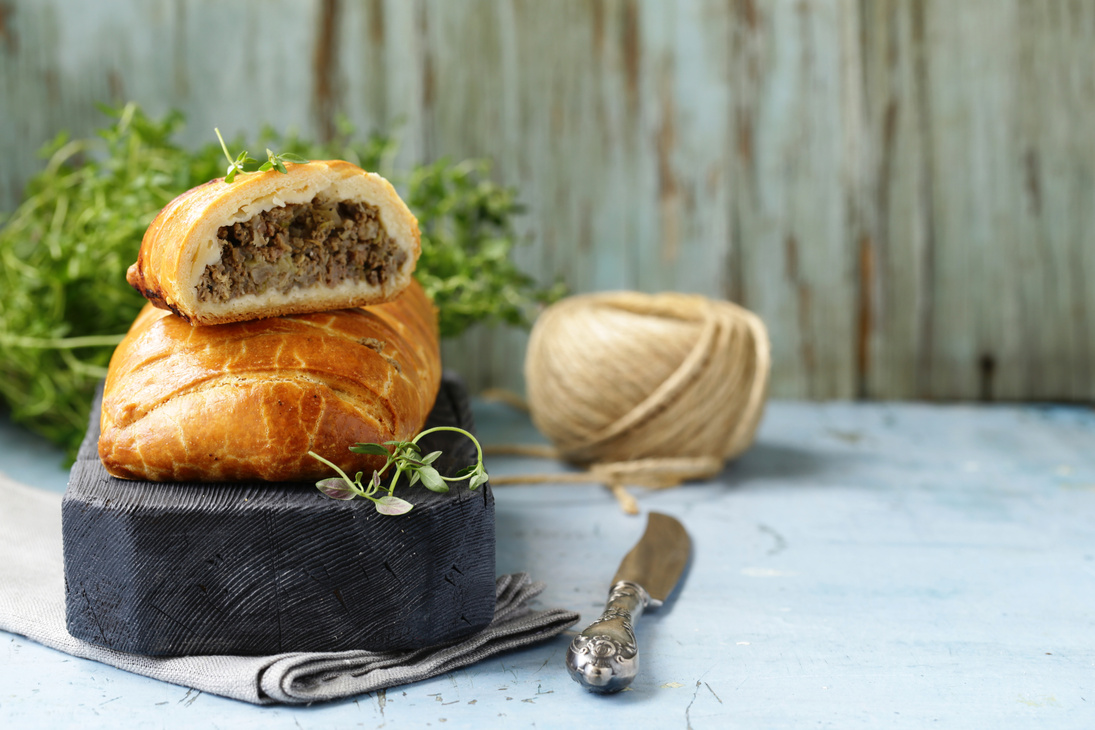 Puff Pastry Pie with Meat on a Wooden Board