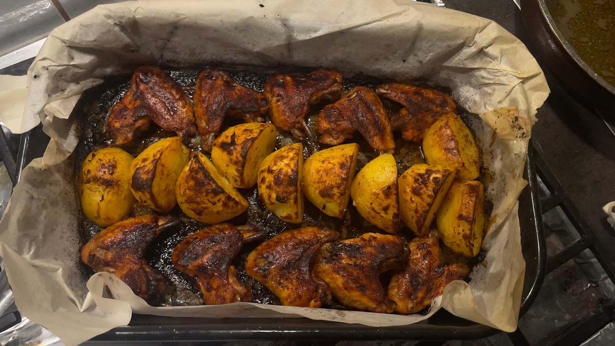 Wings and potatoes at oven dish
