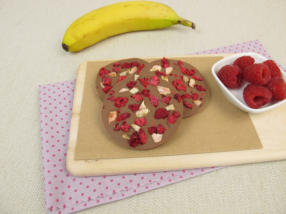 Homemade chocolate coins with raspberry and banana